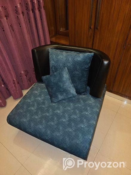 Single sofa with two throw pillows