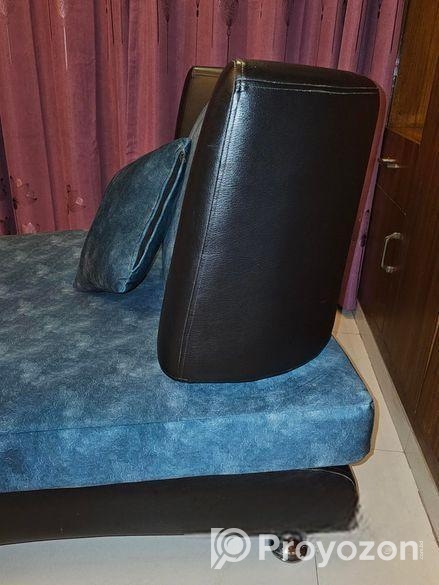 Single sofa with two throw pillows