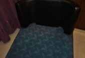 Single sofa with two throw pillows