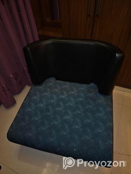 Single sofa with two throw pillows